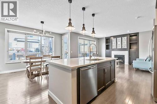 94 Cimarron Springs Circle, Okotoks, AB - Indoor Photo Showing Kitchen With Fireplace With Upgraded Kitchen