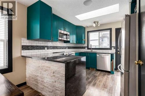 140 Stonegate Close Nw, Airdrie, AB - Indoor Photo Showing Kitchen With Stainless Steel Kitchen