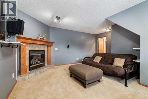 140 Stonegate Close Nw, Airdrie, AB - Indoor Photo Showing Other Room With Fireplace