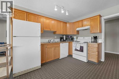 208, 6118 53 Avenue, Red Deer, AB - Indoor Photo Showing Kitchen With Double Sink