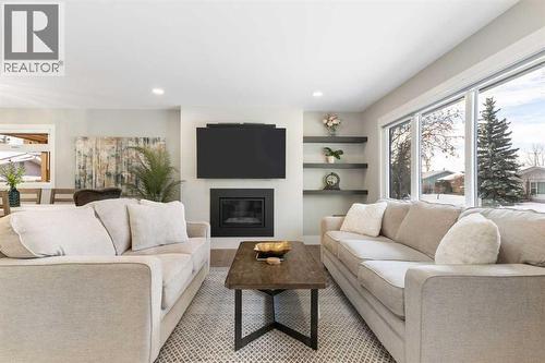 9936 Maplecreek Drive Se, Calgary, AB - Indoor Photo Showing Living Room With Fireplace