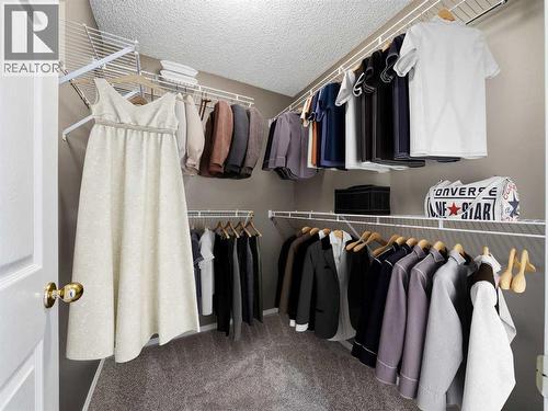 Walk-in Closet (virtually staged) - 626 Hawkstone Manor Nw, Calgary, AB - Indoor With Storage
