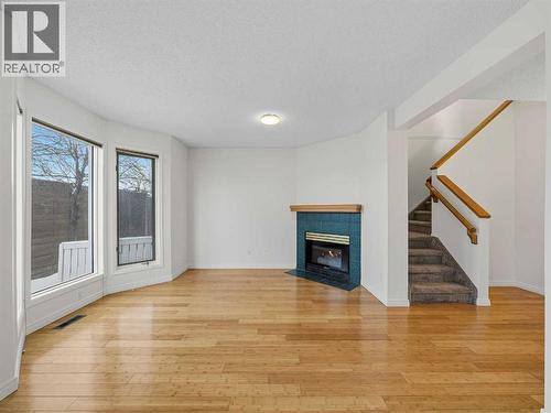 626 Hawkstone Manor Nw, Calgary, AB - Indoor Photo Showing Living Room With Fireplace
