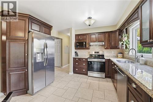 Kitchen hallway to bathroom, mudroom and garage - 84 Chatterson Drive, Ancaster, ON - Indoor Photo Showing Kitchen With Upgraded Kitchen