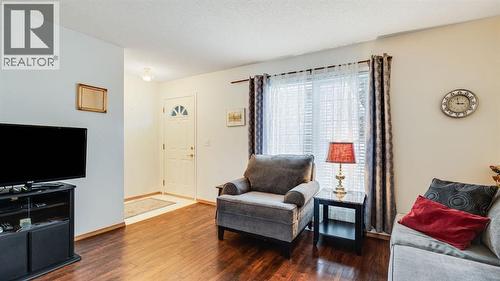 Entryway into living room - 42, 105 Elm Place, Okotoks, AB - Indoor Photo Showing Living Room