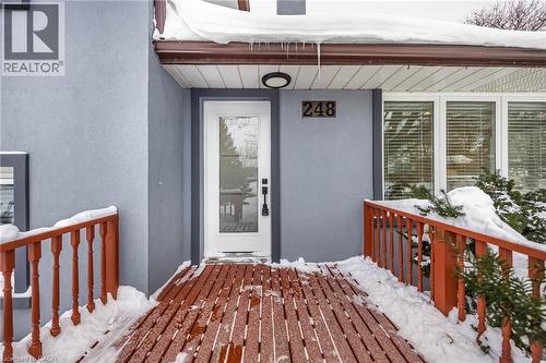 Snow covered property entrance with stucco siding and a deck - 248 Wales Crescent, Oakville, ON - Outdoor With Exterior