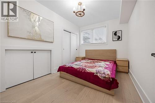 Bedroom featuring hardwood / wood-style floors, a closet, and a chandelier - 248 Wales Crescent, Oakville, ON - Indoor Photo Showing Bedroom