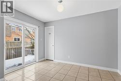 Unfurnished room with baseboards and light tile patterned floors - 