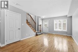 Foyer entrance with stairway and light wood-style flooring - 