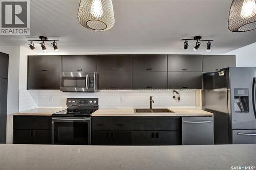 223 120 23Rd Street E, Saskatoon, SK - Indoor Photo Showing Kitchen With Double Sink