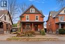 American foursquare style home featuring brick siding and covered porch - 58 Hohner Avenue, Kitchener, ON  - Outdoor With Deck Patio Veranda With Facade 
