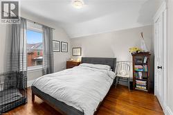 Bedroom featuring wood finished floors and lofted ceiling - 