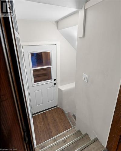Doorway to outside with wood finished floors and stairs - 58 Hohner Avenue, Kitchener, ON - Indoor Photo Showing Other Room