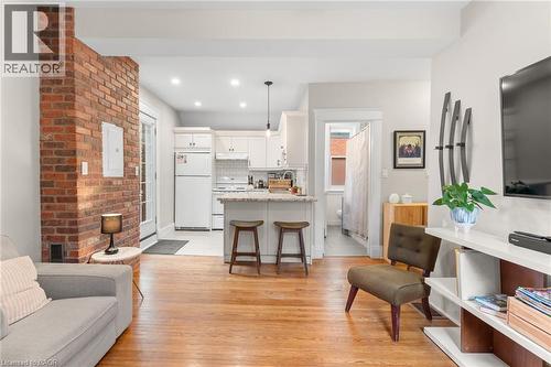 Living area featuring light wood-style flooring, recessed lighting, and electric panel - 58 Hohner Avenue, Kitchener, ON - Indoor Photo Showing Living Room