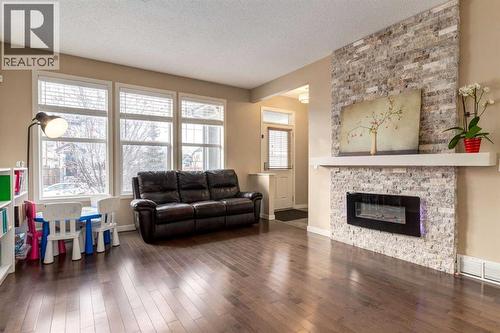 152 New Brighton Grove Se, Calgary, AB - Indoor Photo Showing Living Room With Fireplace