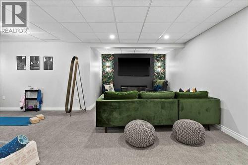 Lower family room with remote electric fireplace - 255 Gleneagles View, Cochrane, AB - Indoor