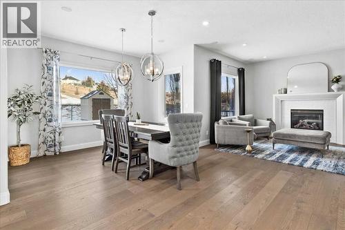 Dining area - 255 Gleneagles View, Cochrane, AB - Indoor With Fireplace