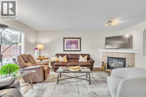 103 Panamount Crescent Nw, Calgary, AB - Indoor Photo Showing Living Room With Fireplace