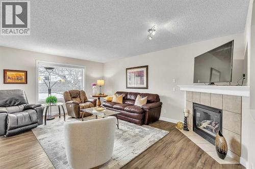 103 Panamount Crescent Nw, Calgary, AB - Indoor Photo Showing Living Room With Fireplace