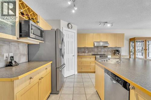 103 Panamount Crescent Nw, Calgary, AB - Indoor Photo Showing Kitchen With Double Sink