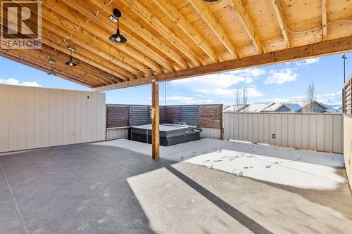 Deck With Hot Tub - 110 Heritage Place Ne, Cochrane, AB - Outdoor With Exterior