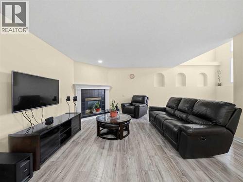 109 Somerset Close Sw, Calgary, AB - Indoor Photo Showing Living Room With Fireplace