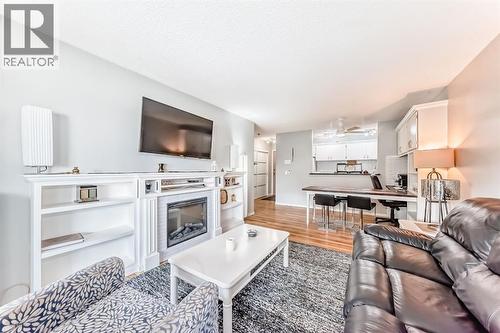 306, 1712 38 Street Se, Calgary, AB - Indoor Photo Showing Living Room With Fireplace