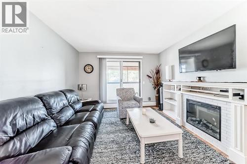 306, 1712 38 Street Se, Calgary, AB - Indoor Photo Showing Living Room With Fireplace