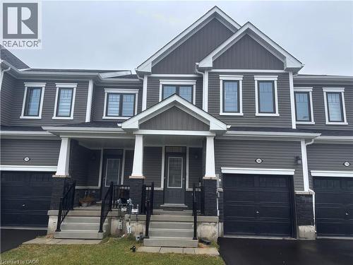 Craftsman-style house featuring covered porch, an attached garage, and driveway - 106 Selection Heights, Thorold, ON - Outdoor With Facade