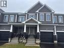 Craftsman-style house featuring covered porch, an attached garage, and driveway - 106 Selection Heights, Thorold, ON  - Outdoor With Facade 