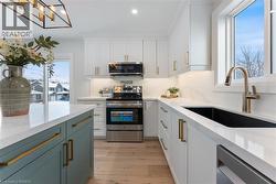 Bright & modern design with quartz countertop & backsplash, contrasting island, pot-filler, and stainless steel appliances. - 