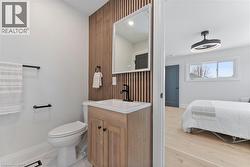 Ensuite bath with beautiful slat feature wall, linen closet, and walk-in closet. - 