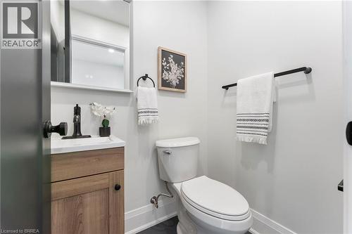Convenient 2pc bath with upgraded ceramic tile flooring. - 50 Fife Street W, Caledonia, ON - Indoor Photo Showing Bathroom