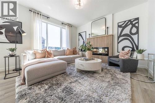 43 Verdure Gate Sw, Calgary, AB - Indoor Photo Showing Living Room With Fireplace