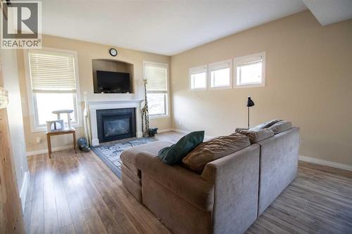 Living Room - 408, 150 Vanier Drive, Red Deer, AB - Indoor Photo Showing Living Room With Fireplace