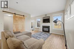 Living room with barn door to basement - 