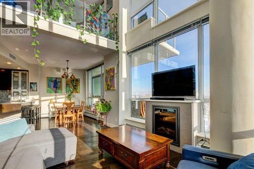 Your gas firepalce for chilly evenings - 602, 99 Spruce Place Sw, Calgary, AB - Indoor Photo Showing Living Room With Fireplace