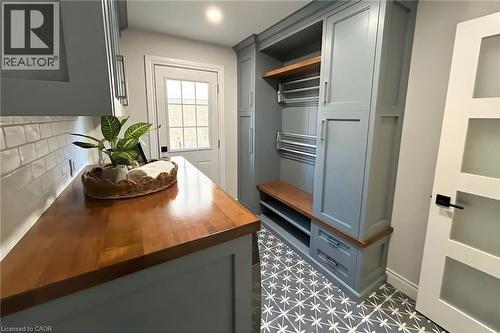 Fully renovated laundry room (2023) with custom cabinetry, abundant storage, and the added convenience of a second-floor laundry chute. - 391 Strawberry Crescent, Waterloo, ON - Indoor Photo Showing Other Room