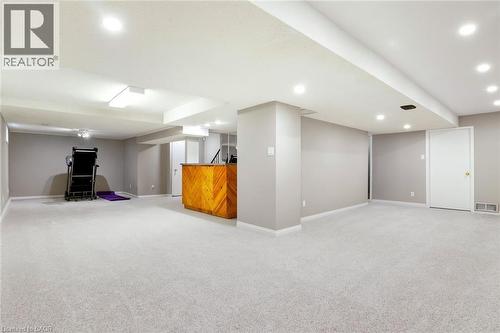 L-shaped basement rec room designed for family living, with room to create distinct zones for play, relaxing, and entertaining. Image has been virtually enhanced to show carpet for visualization pu - 391 Strawberry Crescent, Waterloo, ON - Indoor Photo Showing Basement