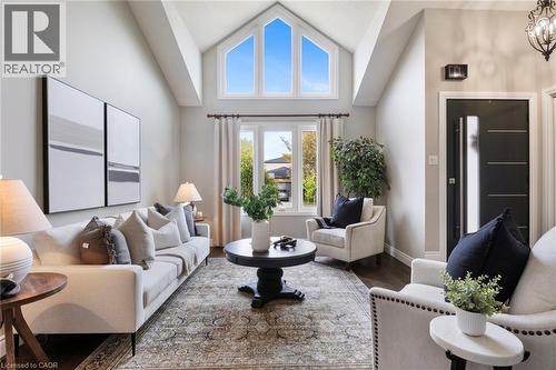 Sunken living room with soaring cathedral ceilings and abundant natural light, creating a bright and welcoming space. - 391 Strawberry Crescent, Waterloo, ON - Indoor Photo Showing Living Room