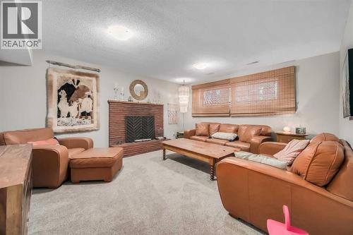 10427 Wapiti Drive Se, Calgary, AB - Indoor Photo Showing Living Room With Fireplace