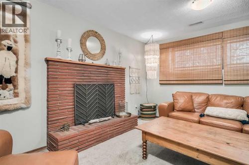 10427 Wapiti Drive Se, Calgary, AB - Indoor Photo Showing Living Room With Fireplace
