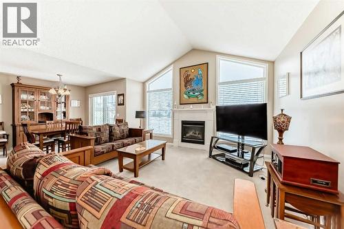 Vaulted Ceiling - 417 Hope Bay, Rural Rocky View County, AB - Indoor Photo Showing Living Room With Fireplace