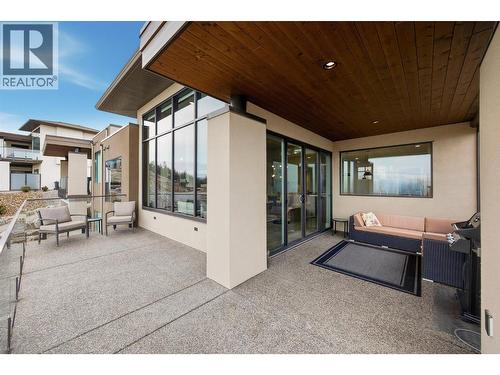 Expansive, main level lake view balcony stretches full width of the home - 468 Sparrow Hawk Court, Kelowna, BC - Outdoor With Exterior