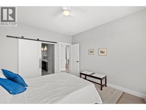 Sliding barn door to ensuite - 468 Sparrow Hawk Court, Kelowna, BC - Indoor Photo Showing Bedroom