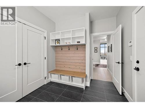 A great zone with lots of storage, a closet and a built-in bench, hooks & shelves. - 468 Sparrow Hawk Court, Kelowna, BC - Indoor Photo Showing Other Room
