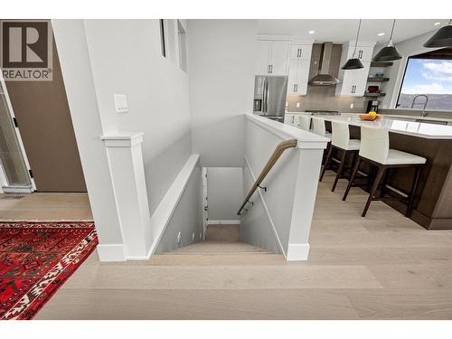 Lit stairs to basement/lower level - 468 Sparrow Hawk Court, Kelowna, BC - Indoor Photo Showing Other Room
