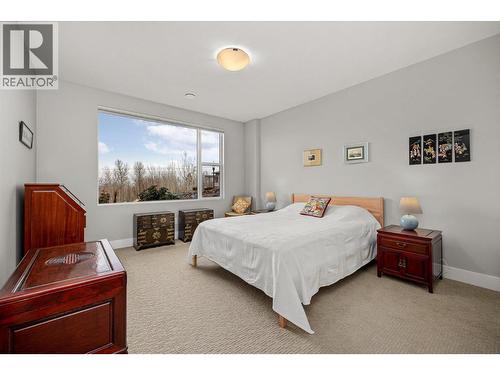 King-size 2nd bedroom with lake views and plush carpet - 468 Sparrow Hawk Court, Kelowna, BC - Indoor Photo Showing Bedroom