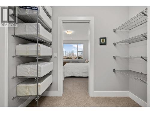 Walk-through closet leading to a cheater ensuite - 468 Sparrow Hawk Court, Kelowna, BC - Indoor With Storage