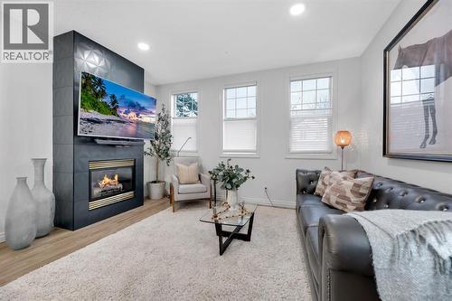 12, 10 St Julien Drive Sw, Calgary, AB - Indoor Photo Showing Living Room With Fireplace